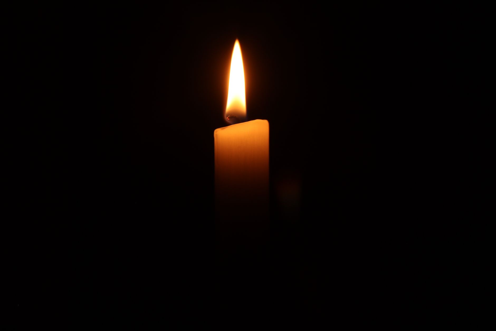 A single candle lit in remembrance