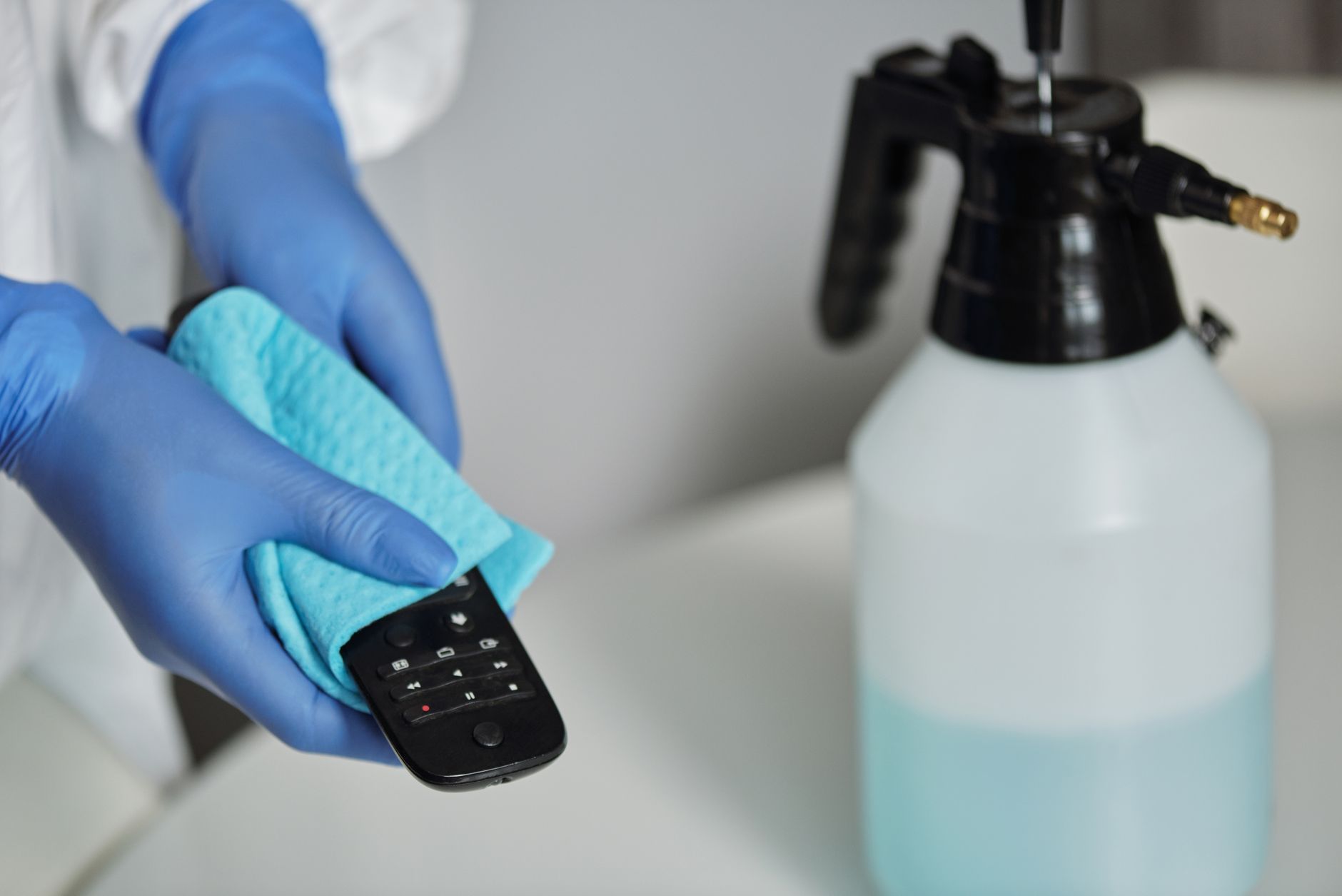 A trained technician in protective equipment disinfecting a home